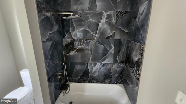 bathroom with toilet and shower / washtub combination