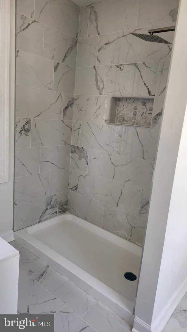 full bath featuring a bathing tub, baseboards, marble finish floor, and a shower