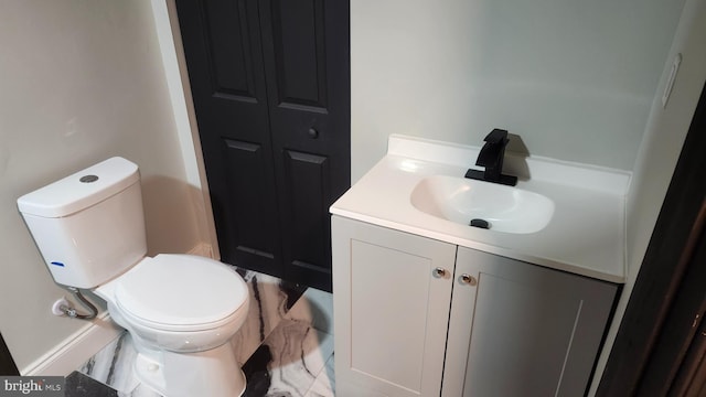bathroom featuring toilet and vanity