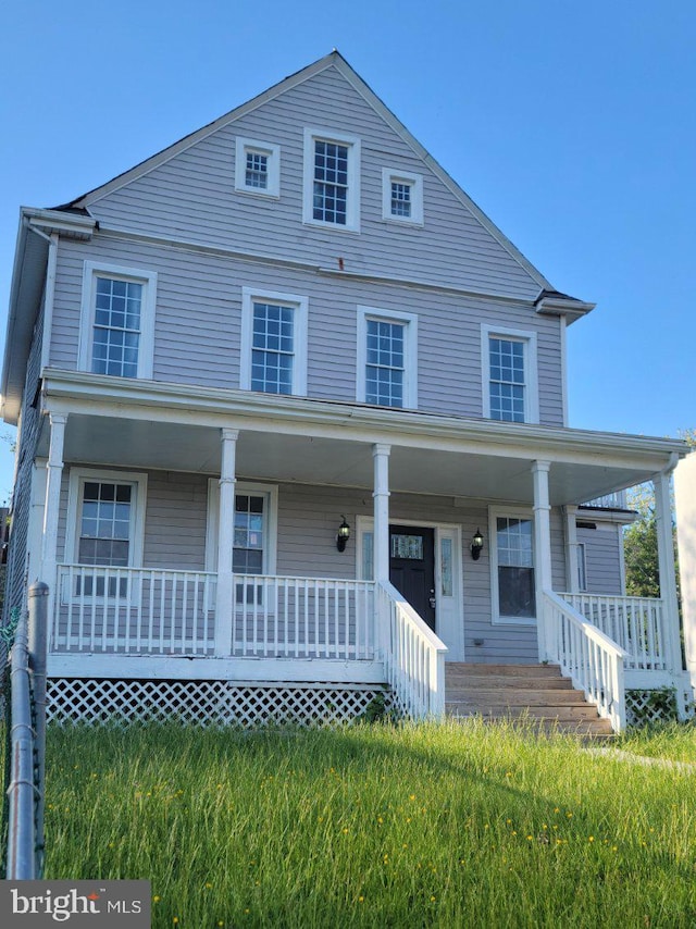 view of front of home with a porch and a front lawn