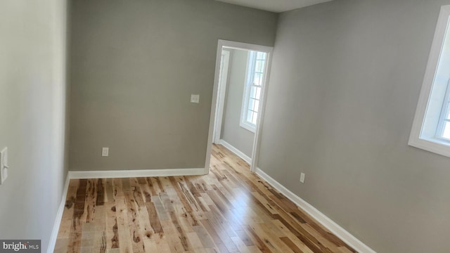 unfurnished room featuring baseboards and wood finished floors