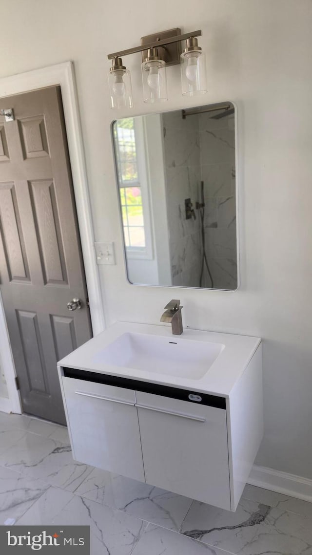 full bathroom featuring baseboards, a marble finish shower, marble finish floor, and vanity