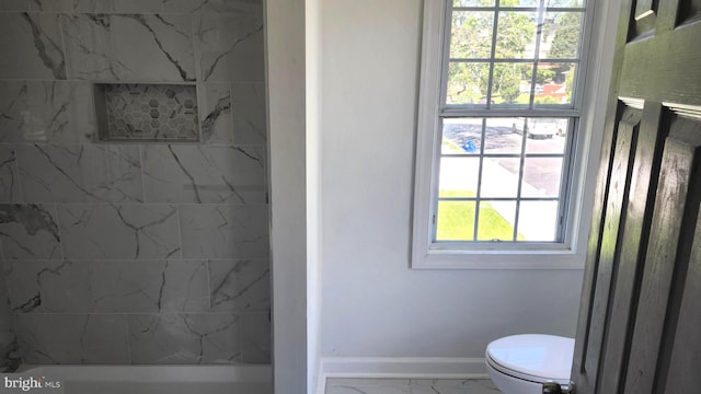 bathroom featuring baseboards, marble finish floor, walk in shower, and toilet