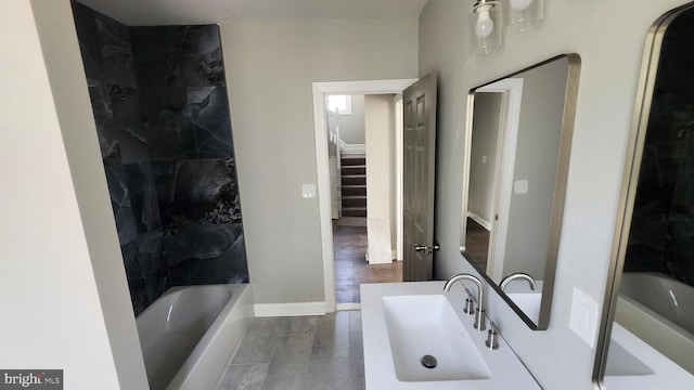 full bath with baseboards and vanity