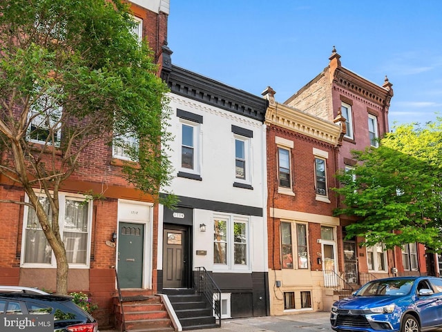 townhome / multi-family property with brick siding