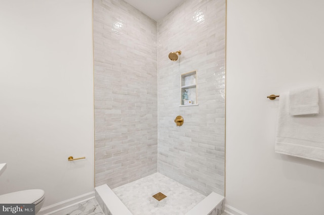 bathroom with baseboards, a tile shower, toilet, and marble finish floor
