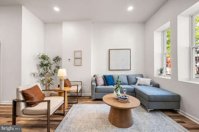 living area with baseboards, recessed lighting, and wood finished floors
