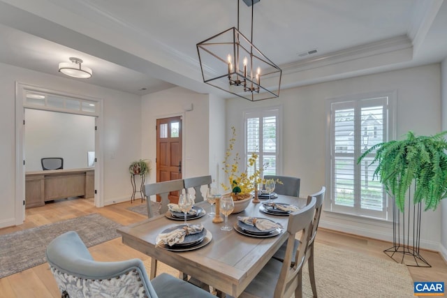 dining area with visible vents, ornamental molding, baseboards, and light wood-type flooring
