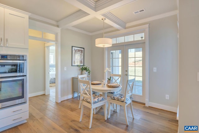 dining space with crown molding, beamed ceiling, light wood-type flooring, and visible vents