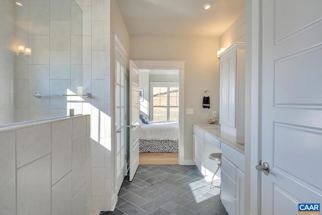 ensuite bathroom with walk in shower, a sink, ensuite bath, tile patterned floors, and recessed lighting
