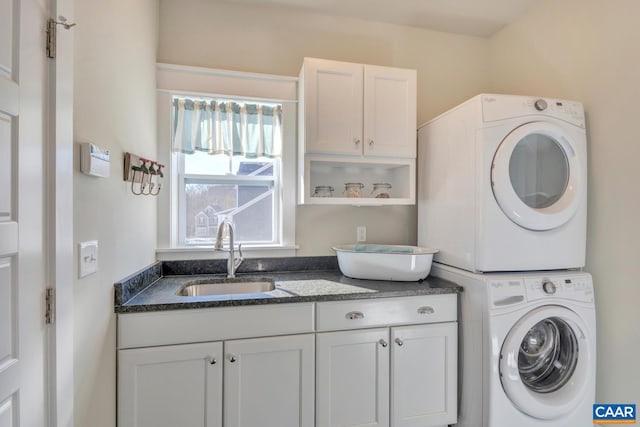 laundry room with a sink, stacked washer and clothes dryer, and cabinet space