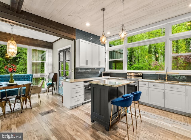 117 Holly Ln, Pilesgrove, NJ 08098 - kitchen with a sink, tasteful backsplash, white cabinets, beamed ceiling, and light wood-type flooring
