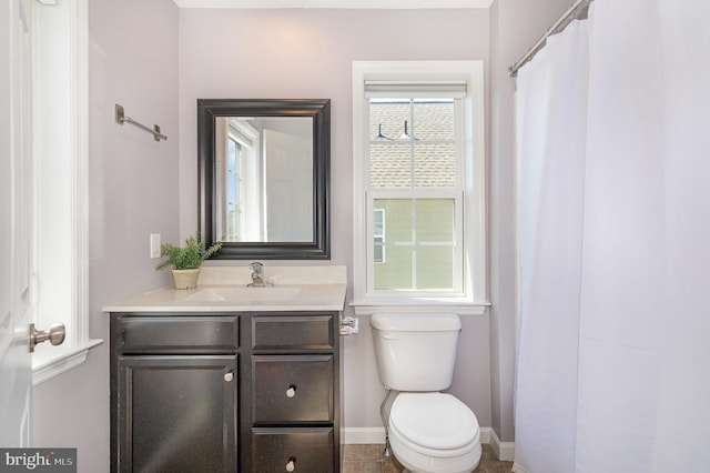 full bathroom featuring vanity, baseboards, and toilet