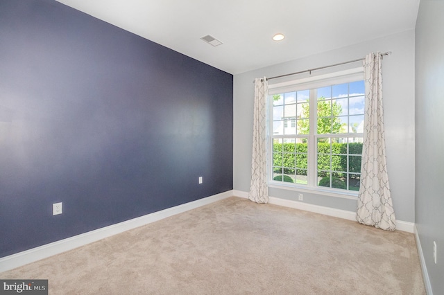 carpeted empty room with baseboards, recessed lighting, and visible vents