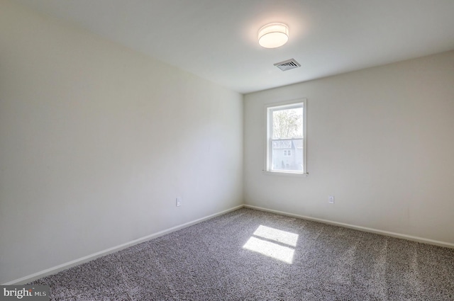 unfurnished room featuring carpet flooring, baseboards, and visible vents