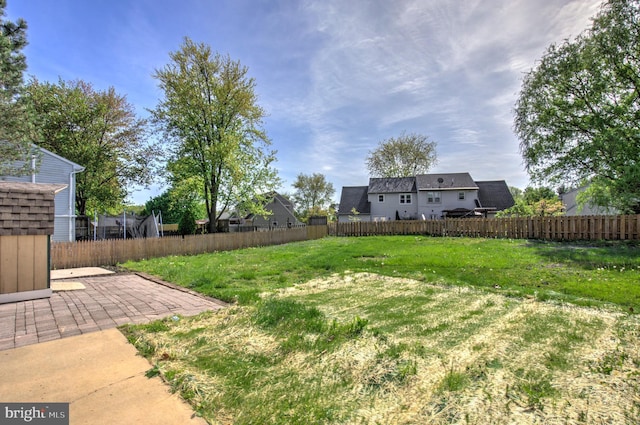 view of yard with fence and a patio area