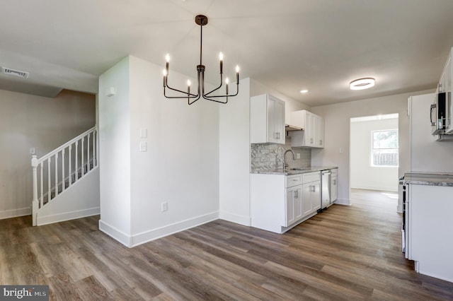 kitchen featuring a sink, baseboards, and dark wood-style flooring