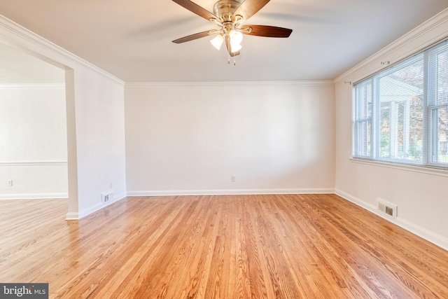 spare room with visible vents, a ceiling fan, light wood-style flooring, and baseboards