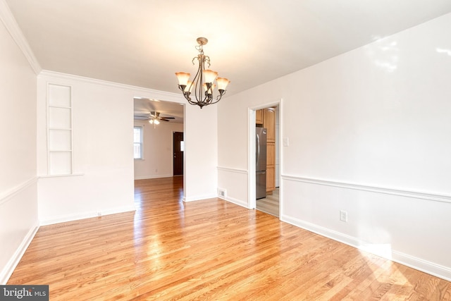 unfurnished dining area with baseboards, ceiling fan with notable chandelier, light wood finished floors, and visible vents