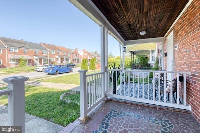 view of patio / terrace featuring a residential view and covered porch