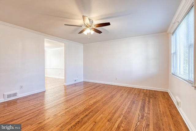 spare room with a ceiling fan, visible vents, and light wood-type flooring