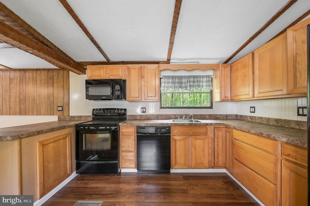 kitchen with dark wood-style flooring, dark countertops, beam ceiling, a sink, and black appliances