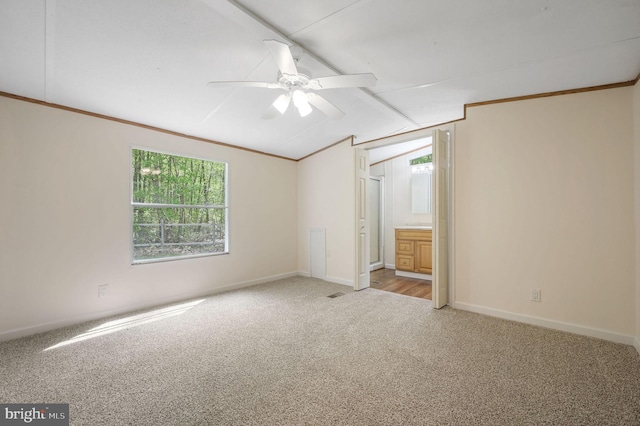 unfurnished bedroom featuring baseboards, carpet flooring, lofted ceiling, and multiple windows