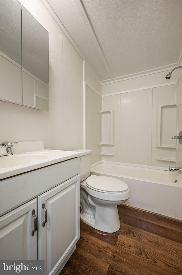 bathroom featuring wood-type flooring, shower / bath combination, toilet, and vanity