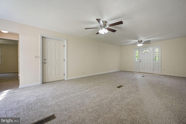 spare room featuring a ceiling fan, baseboards, visible vents, and carpet