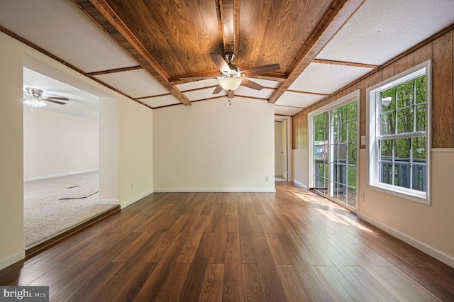 spare room with baseboards, a ceiling fan, and hardwood / wood-style floors