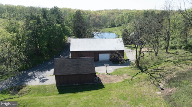 bird's eye view featuring a water view and a view of trees
