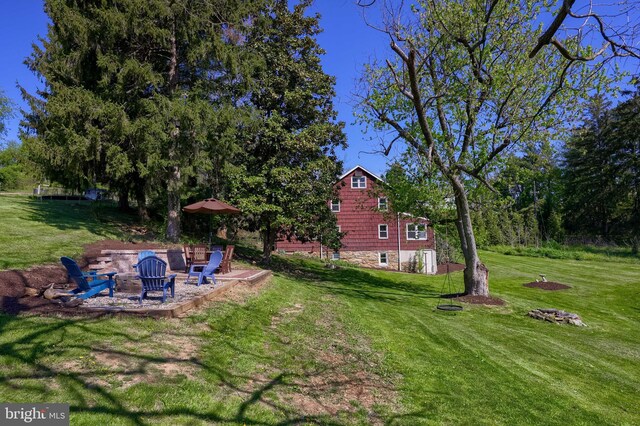 view of yard featuring a patio and a fire pit