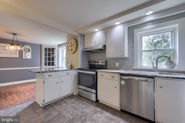 kitchen featuring white cabinetry, a peninsula, appliances with stainless steel finishes, and under cabinet range hood