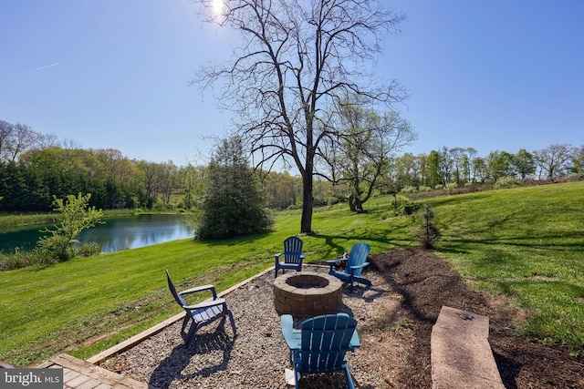 view of yard with an outdoor fire pit and a water view