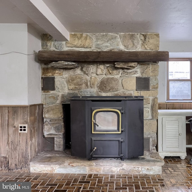 details with wainscoting, wood walls, and visible vents