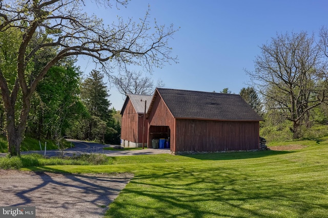 view of property exterior with a yard, an outbuilding, and a barn