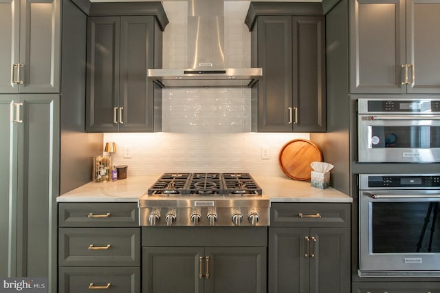 362 Star Tavern Ln, West Chester, PA 19382 - kitchen with light countertops, gray cabinets, wall chimney exhaust hood, stainless steel appliances, and decorative backsplash