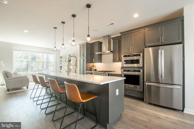 362 Star Tavern Ln, West Chester, PA 19382 - kitchen with visible vents, light wood-style flooring, wall chimney exhaust hood, and stainless steel appliances