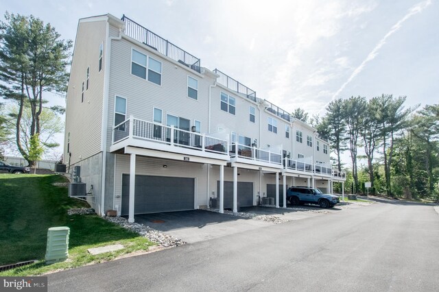 362 Star Tavern Ln, West Chester, PA 19382 - view of building exterior featuring central air condition unit, an attached garage, and aphalt driveway