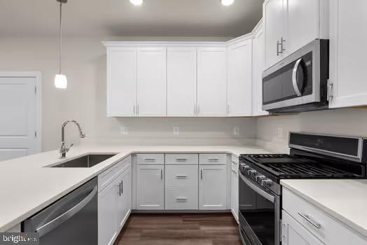 136 Salinger Dr Unit 136, Gaithersburg, MD 20878 - kitchen with stainless steel appliances, a sink, white cabinets, light countertops, and recessed lighting