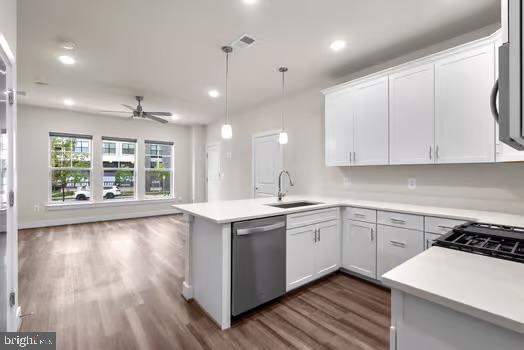 136 Salinger Dr Unit 136, Gaithersburg, MD 20878 - kitchen featuring dishwasher, a sink, dark wood-style flooring, a peninsula, and open floor plan