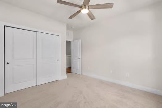 136 Salinger Dr Unit 136, Gaithersburg, MD 20878 - unfurnished bedroom with a closet, baseboards, a ceiling fan, and carpet floors