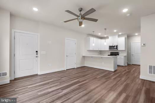 136 Salinger Dr Unit 136, Gaithersburg, MD 20878 - kitchen with stainless steel microwave, a ceiling fan, stove, light countertops, and recessed lighting