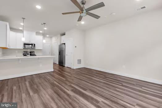 136 Salinger Dr Unit 136, Gaithersburg, MD 20878 - kitchen featuring stainless steel microwave, fridge with ice dispenser, a peninsula, open floor plan, and white cabinetry