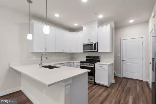 136 Salinger Dr Unit 136, Gaithersburg, MD 20878 - kitchen featuring stainless steel appliances, a sink, white cabinetry, a peninsula, and light countertops