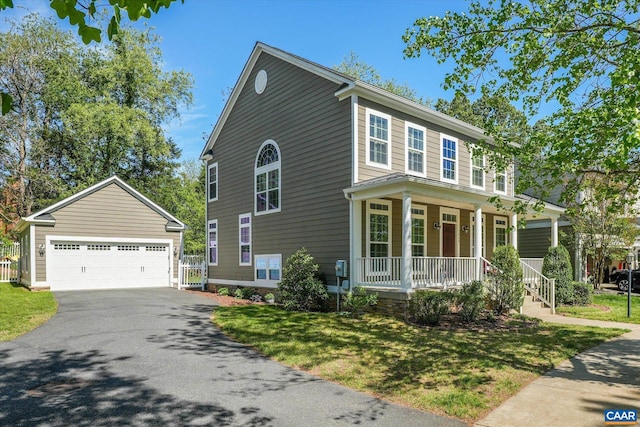 view of front of property with an outdoor structure, a garage, covered porch, and a front yard