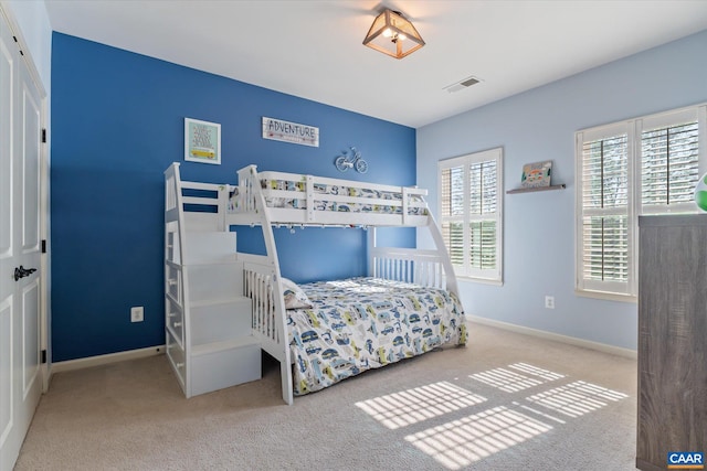 bedroom featuring visible vents, carpet flooring, and baseboards