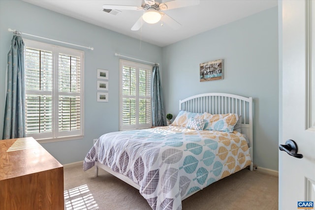 bedroom with baseboards, carpet, a ceiling fan, and visible vents