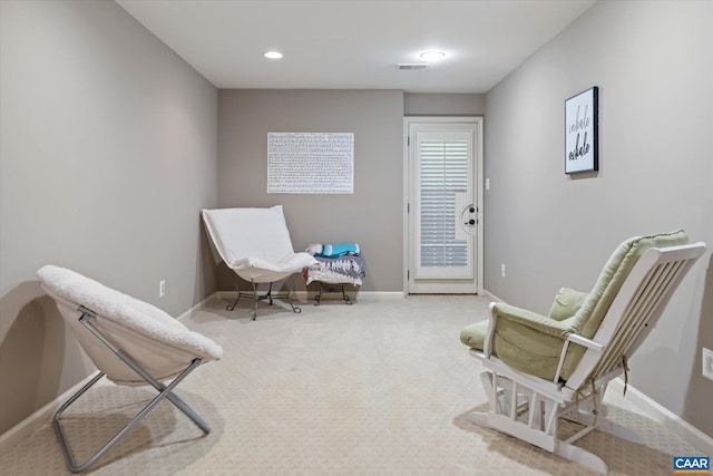 sitting room with baseboards and carpet