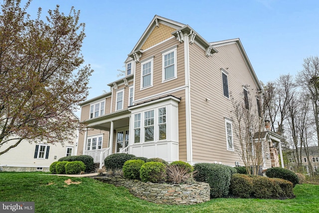 view of front of property with a front yard and a porch
